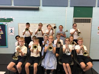 A group of pupils from Grangefield Primary posing with their trumpets