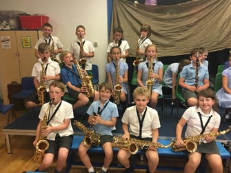 The pupils of Haresfield Primary playing saxophones