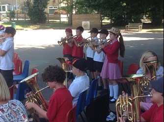 A photo of the tuba players and trombone players playing during the Stratton Primary brass concert